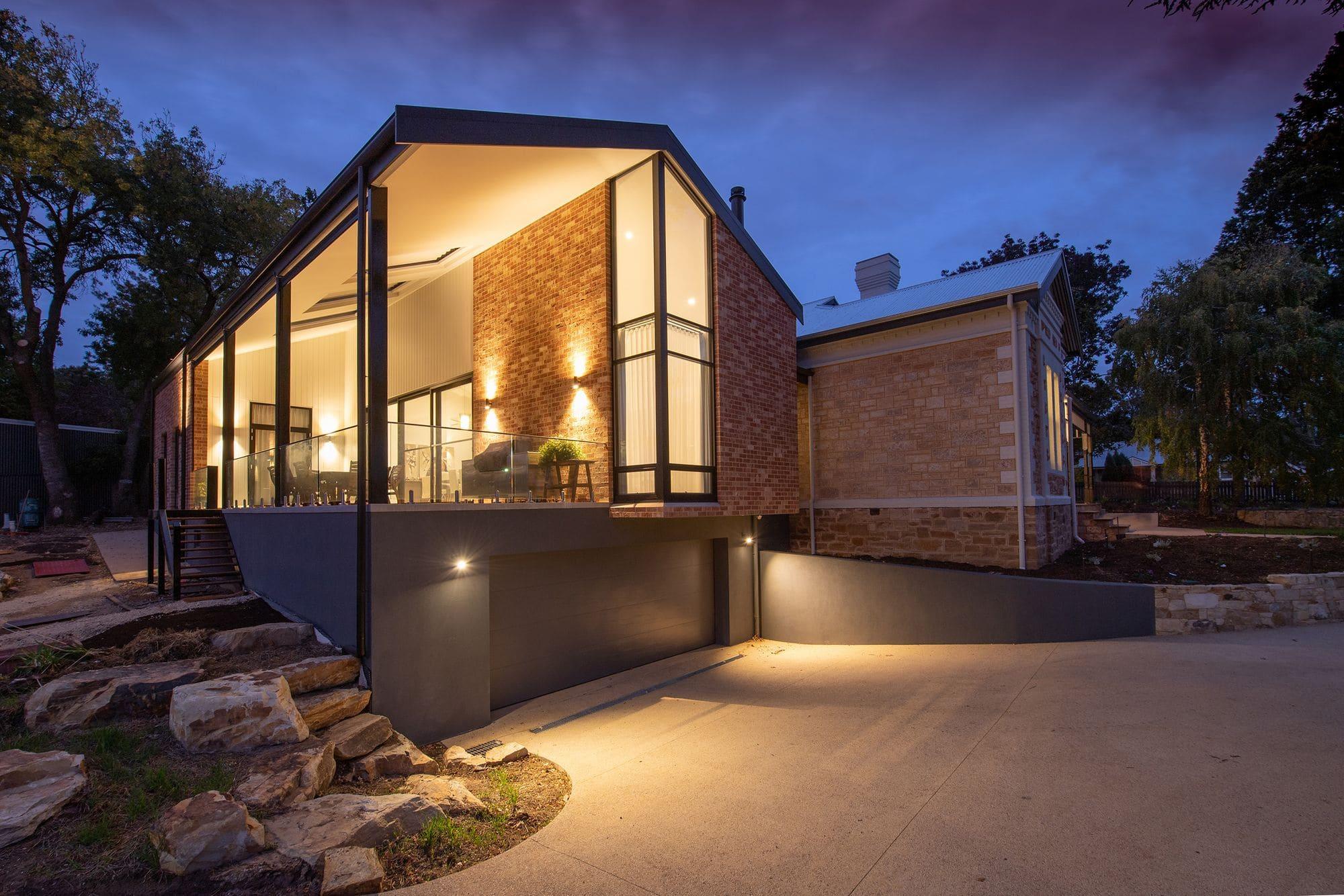 Modern renovated home exterior lit at dusk in Charlotte, NC